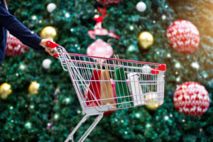 Christmas Shopping Trolly in front of a Christmas Tree
